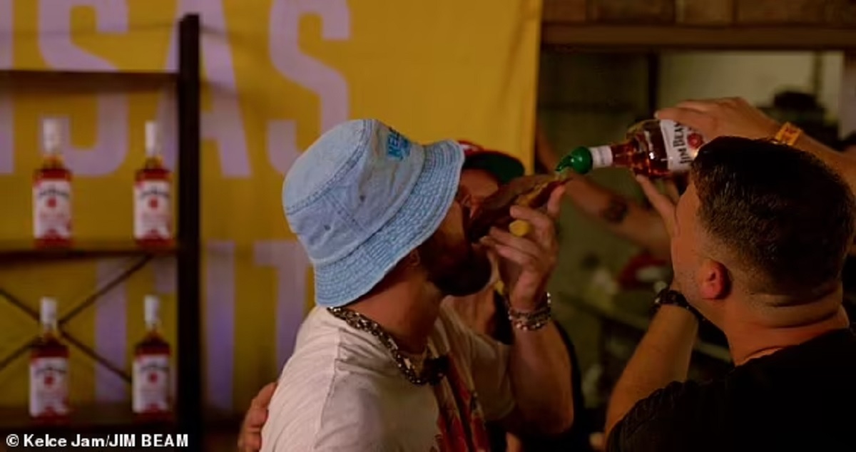 Travis Kelce takes a whiskey shot from a slice of bread and sings on stage with Patrick Mahomes, letting loose at his music festival after leaving his girlfriend Taylor Swift in Europe.