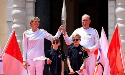 Prince Albert and Princess Charlene of Monaco hold hands as they attend Olympic flame lighting ceremony - while adorable twins Gabriella and Jacques are too cool for school in dark shades