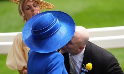 Queen Camilla's wide-brimmed hat obstructs Zara and Mike Tindall as they attempt to greet her with a kiss at Royal Ascot.